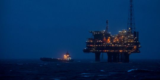 a supply vessel at an oil rig platform at night a supply vessel at an oil rig platform at night