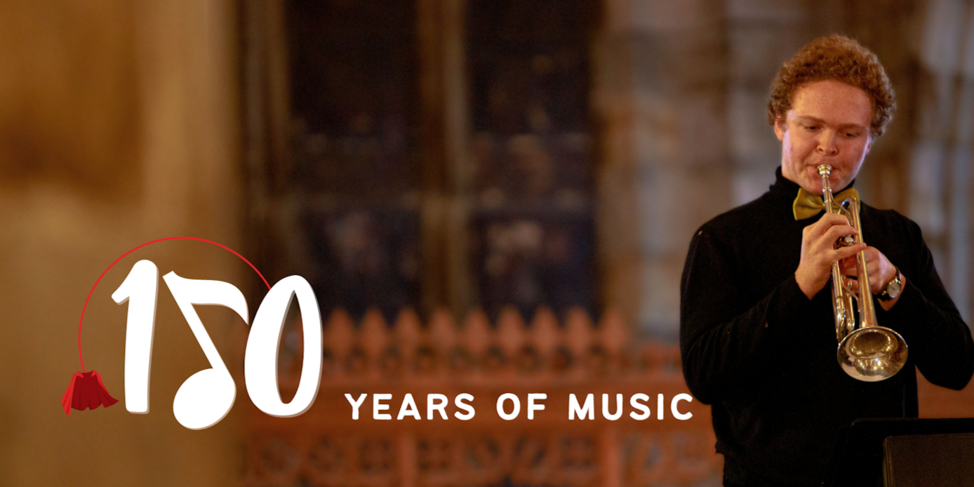 Text reads '150 years of music', the five has been replaced with a musical note. A student in a black shirt and gold bowtie is playing a trumpet on the right of the image, the background is blurred Text reads '150 years of music', the five has been replaced with a musical note. A student in a black shirt and gold bowtie is playing a trumpet on the right of the image, the background is blurred