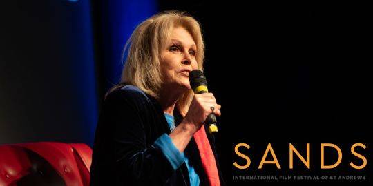 Joanna Lumley on stage with mic at Sands 2024 Joanna Lumley on stage with mic at Sands 2024