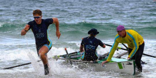 Tom Mitchell can be seen participating in HIRBS, Hansine Marshall can be seen in the boat, held in the water by a teammate Tom Mitchell can be seen participating in HIRBS, Hansine Marshall can be seen in the boat, held in the water by a teammate