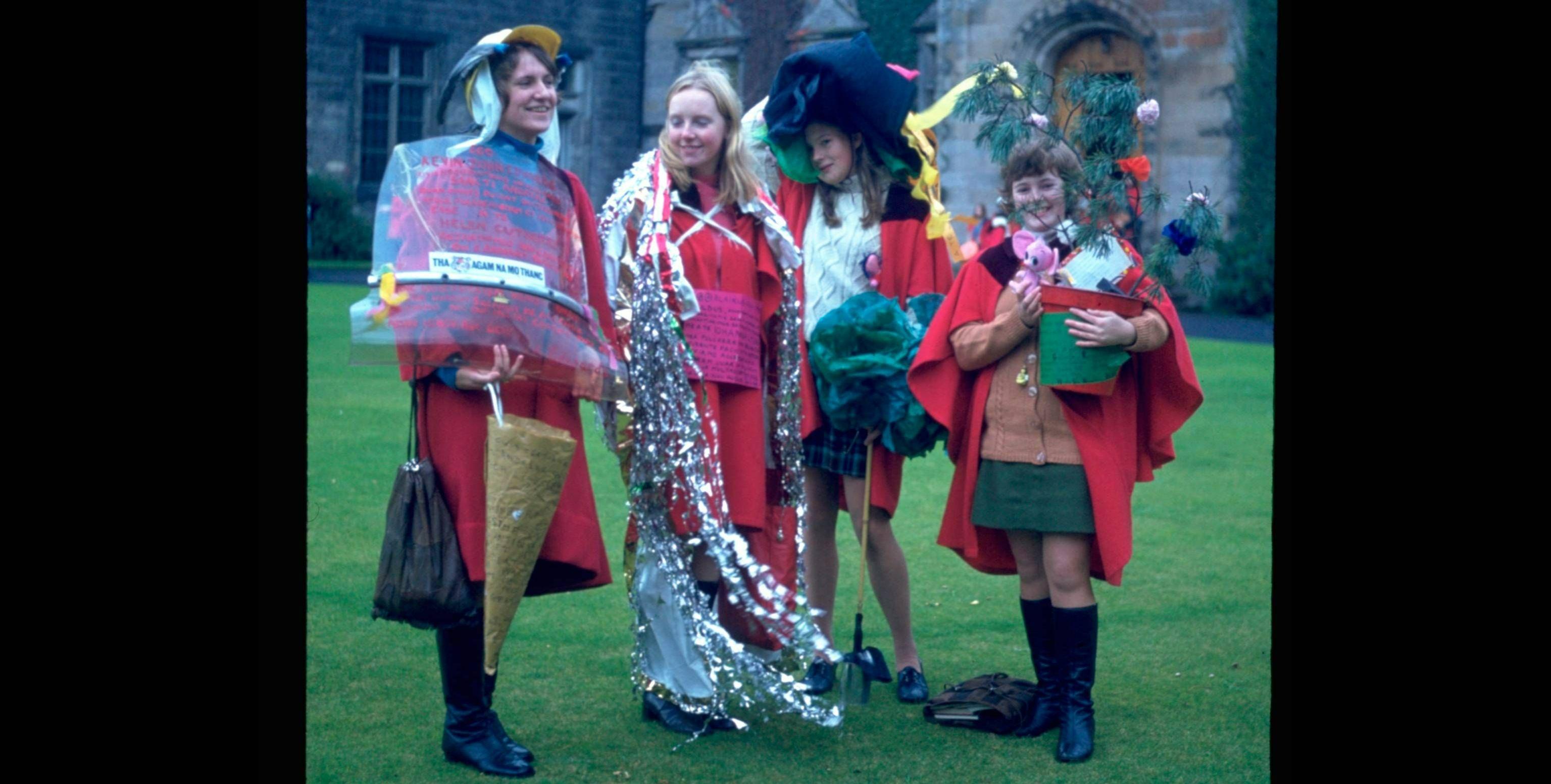 An archive photograph from 1971 featuring students in red gowns