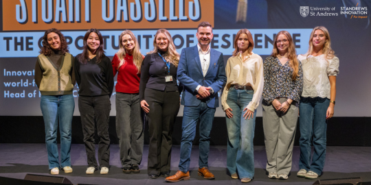 Students with a guest speaker on stage at Innovation Week 2024