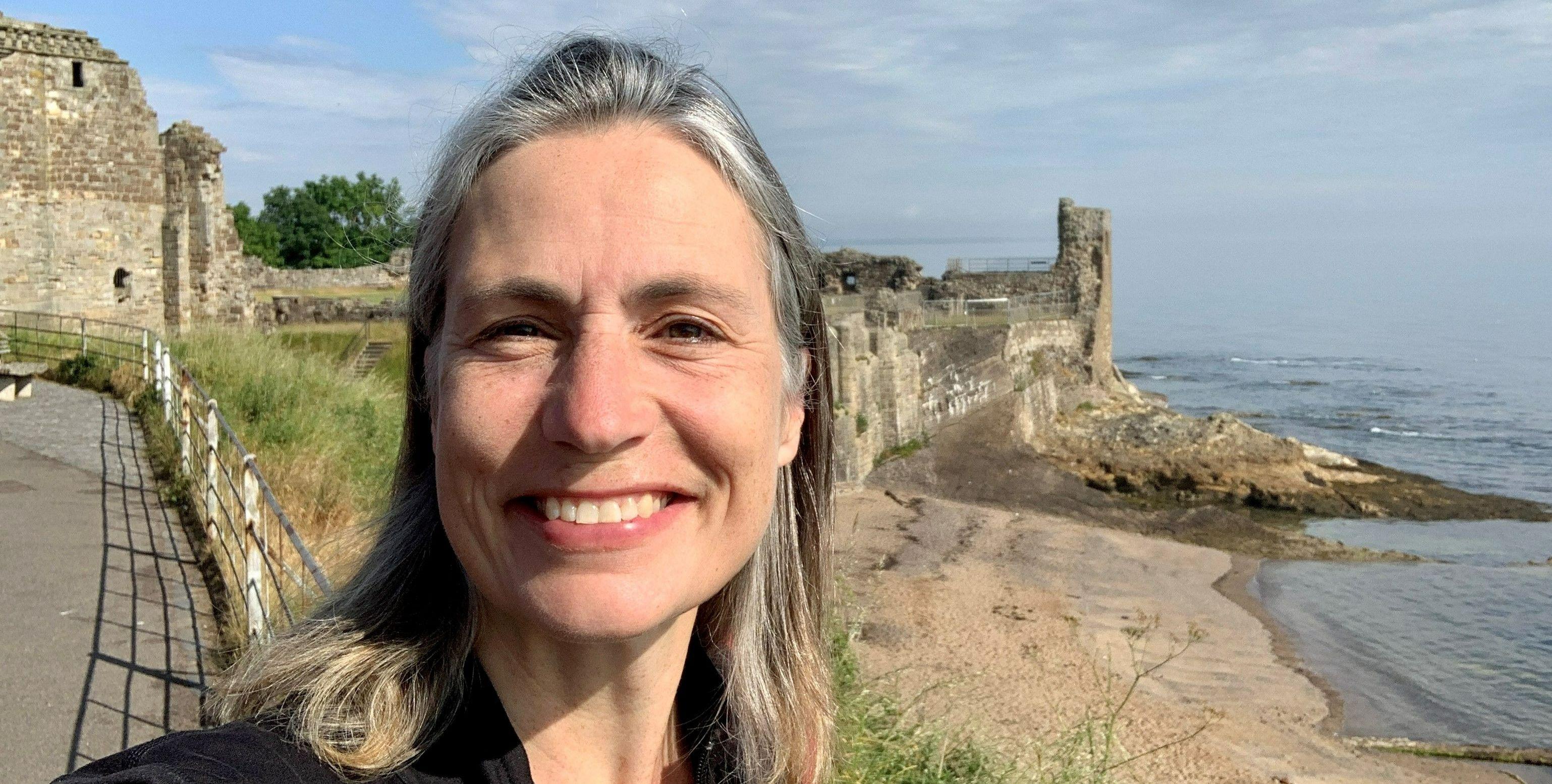 Dr Fiona Hill, pictured by the sea and castle ruins Dr Fiona Hill, pictured by the sea and castle ruins