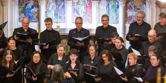 A choral group singing, wearing black A choral group singing, wearing black