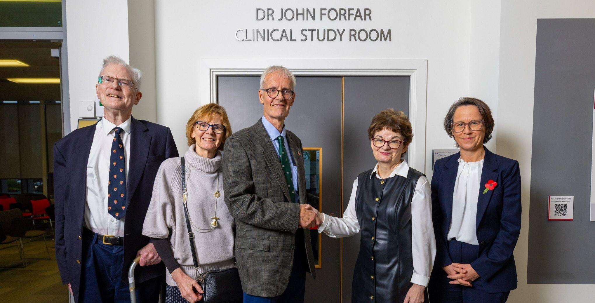 Five Sabbatical Officers walk through St Salvator's Quad, they can be seen to be smiling and laughing. 