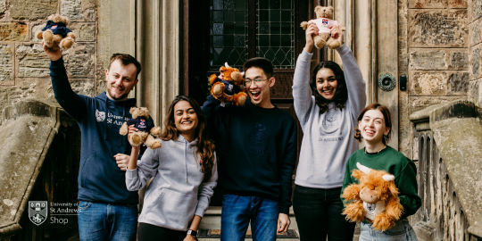 Five university students modelling University of St Andrews branded clothing and holding branded teddy bears. Five university students modelling University of St Andrews branded clothing and holding branded teddy bears.