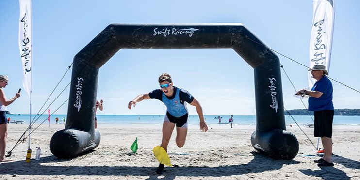 A St Andrews athlete is pictured running across the finish line at a beach sprint championship A St Andrews athlete is pictured running across the finish line at a beach sprint championship