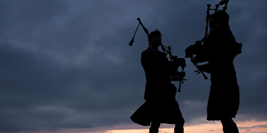 silhouette of two pipers