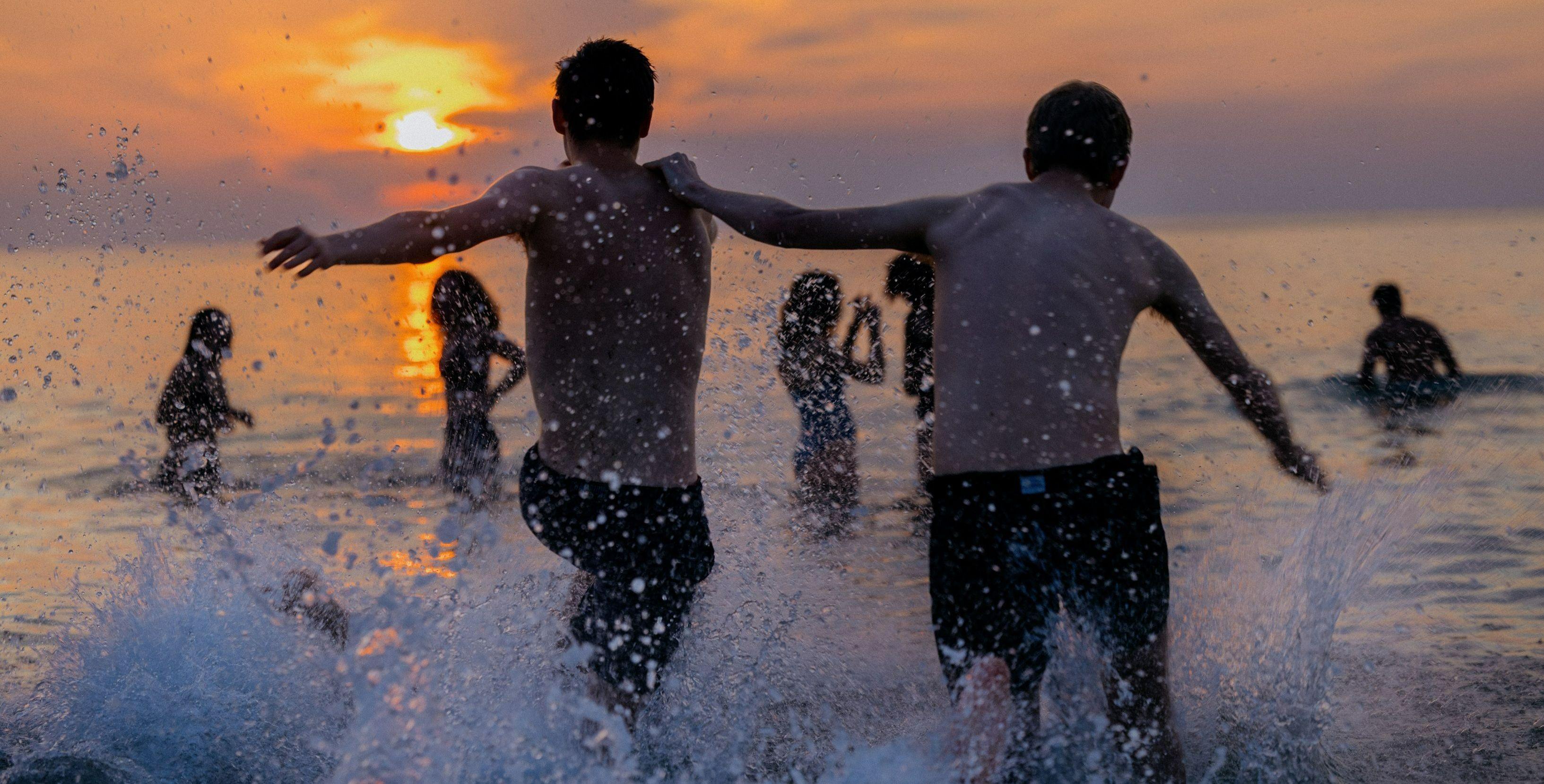 two men splashing into the sea two men splashing into the sea