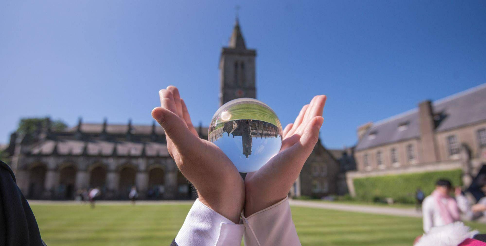 hands with a lens ball in St Salvator's Quad