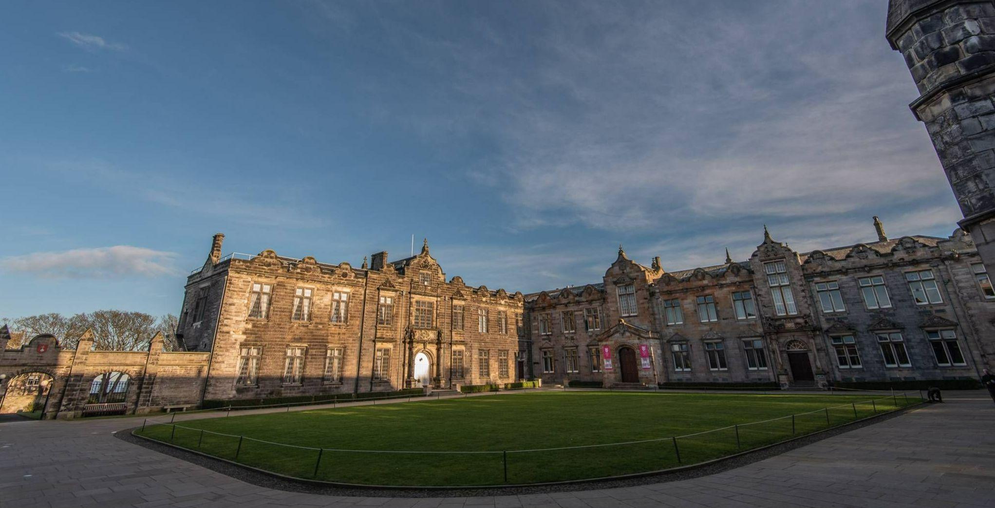 St Salvator's Quad at the University of St Andrews, with the lawn to the centre and grey stone buildings around three edges.