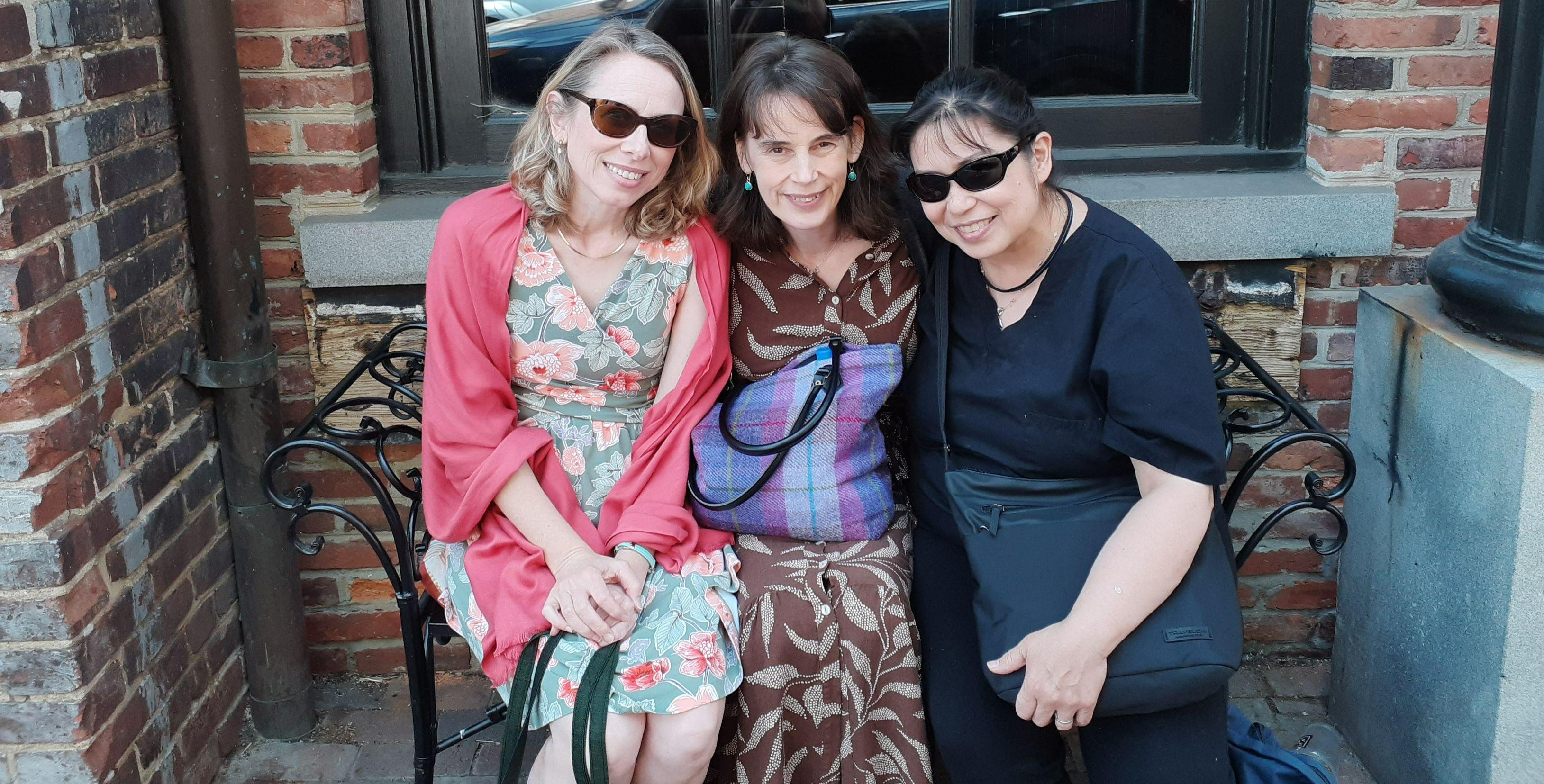 Eight adults standing on a stage at a conference Eight adults standing on a stage at a conference