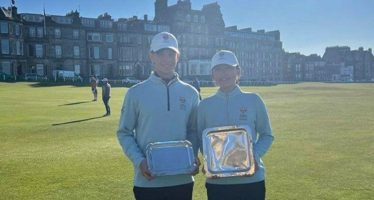 Two golfers on the Old Course, St Andrews, holding trophies Two golfers on the Old Course, St Andrews, holding trophies