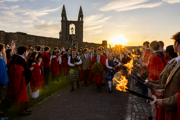students in a torchlit procession students in a torchlit procession
